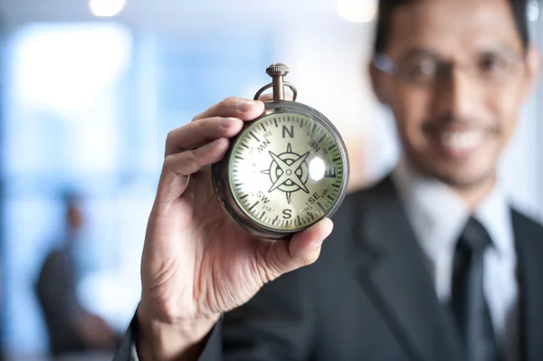 Businessman holding a compass — Stock Photo, Image