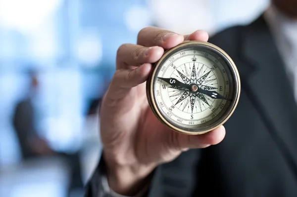 Businessman holding a compass — Stock Photo, Image