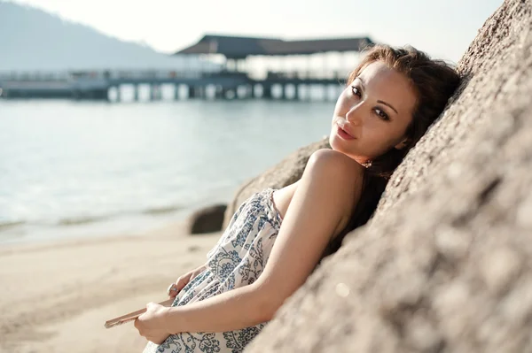 Attractive Asian Female leaning on a rock — Stock Photo, Image