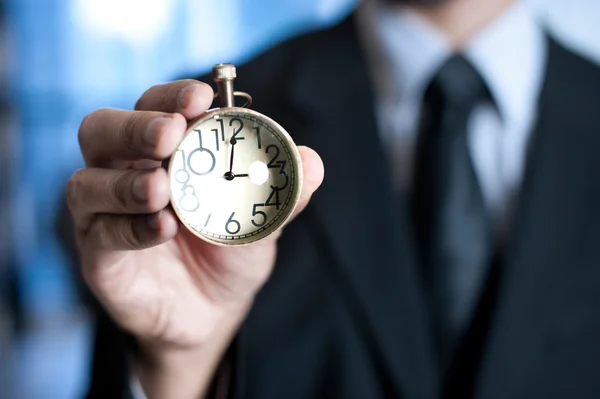 Hand of businessman with clock — Stock Photo, Image