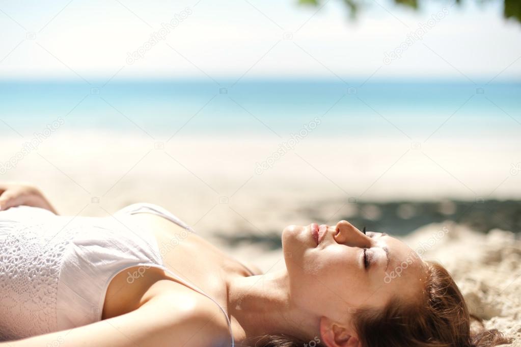 Attractive Asian Female laying on the beach