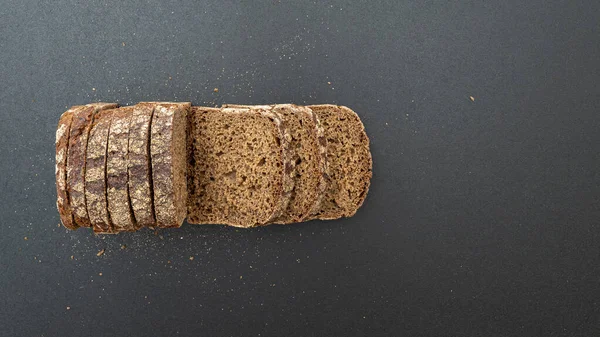Loaf Grain Bread Crumbs Black Wooden Surface Top View — Stock Photo, Image