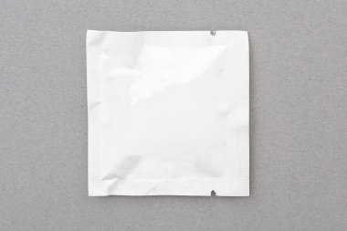 Small foil package by wet antibacterial wipe, mock up, space for text, top view