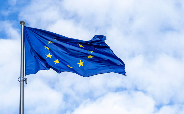 Panoramic view of a waving EU flag or European Union flag against blue sky