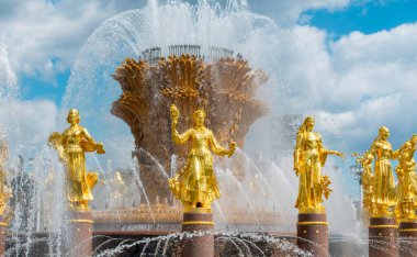 MOSCOW - MAY 02: The Friendship of Nations fountain with golden figures at VDNKh or VDNH  in Moscow, May 02. 2022 in Russia.	