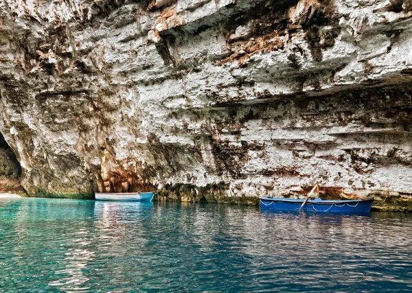 Two wooden boats in old cave with clear blue water — Stok Foto