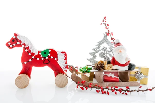 Close up of Santa sitting on wooden horse sledge — Stock Photo, Image