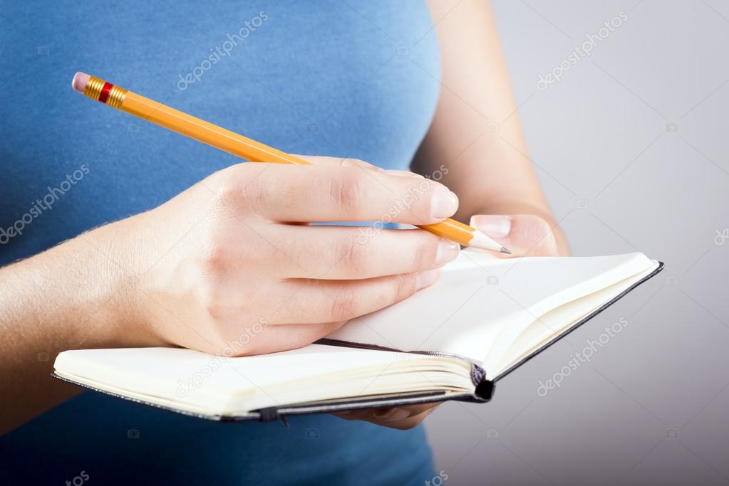 Woman Writing In Notebook