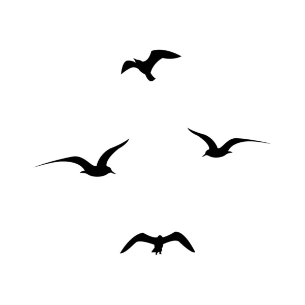 黒い空飛ぶカモメのシルエットのセット — ストックベクタ