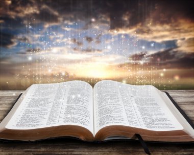 Glowing Bible at sunset clipart
