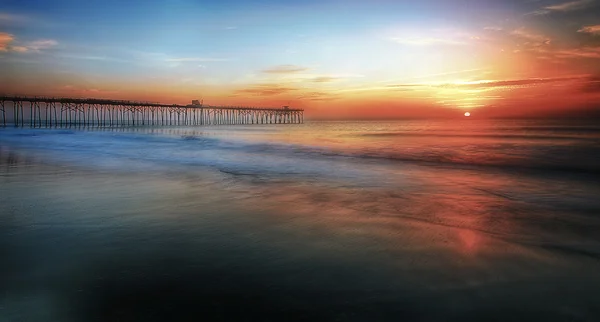 Sunrise by the pier — Stock Photo, Image