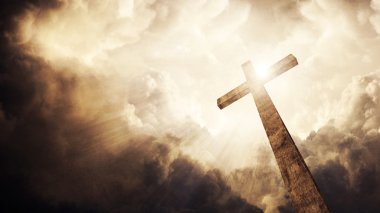 A wooden Christian cross with bright sun and clouds. clipart