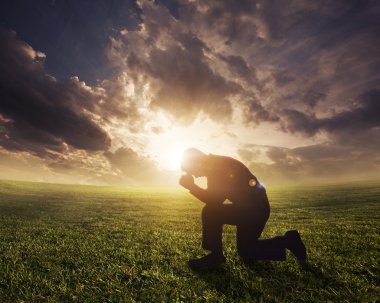 Praying at sunset clipart