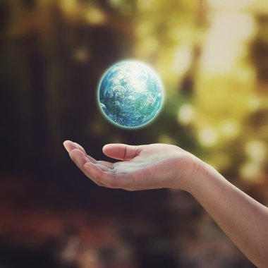 Earth floating in the air and hand