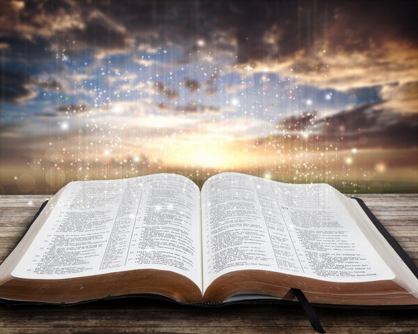 Glowing Bible at sunset