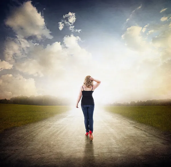 Woman walking on old road with red high heels. — Stock Photo, Image