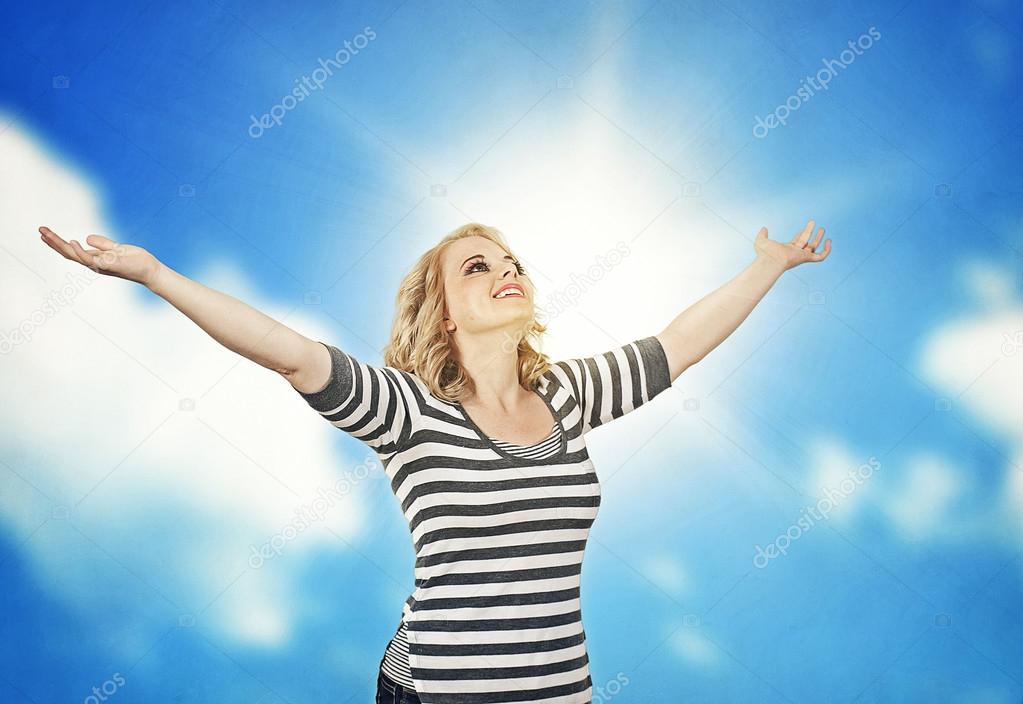 Woman outstretching her arms to the sky