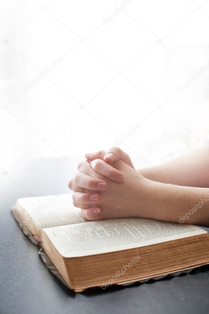 Woman praying on white background