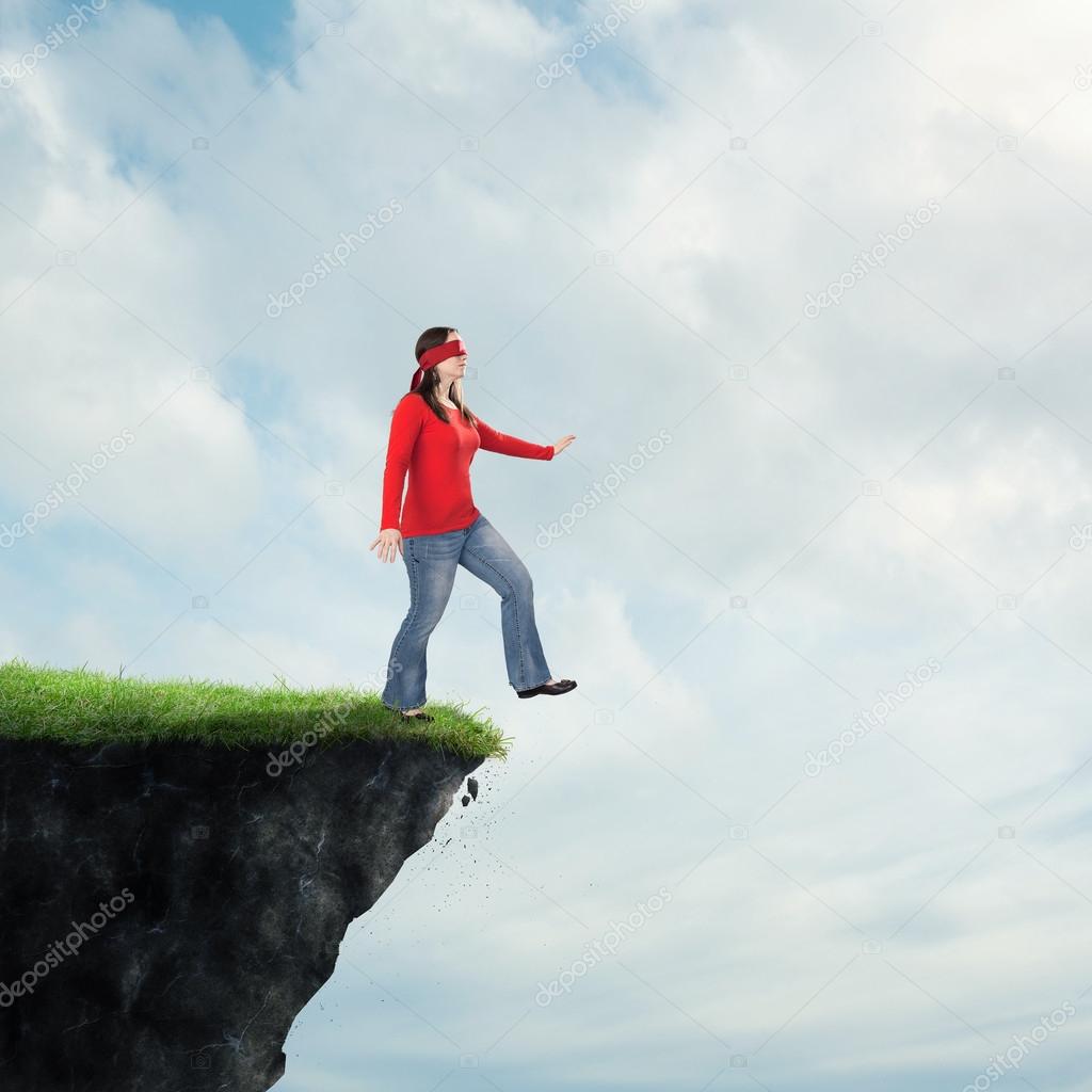 Woman walking off cliff