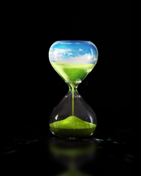 Hourglass with green meadow