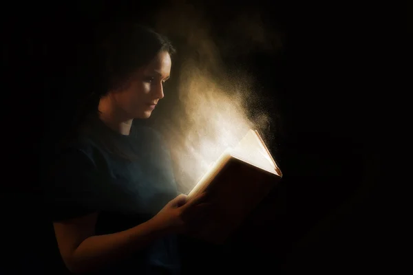 Reading a glowing book — Stock Photo, Image