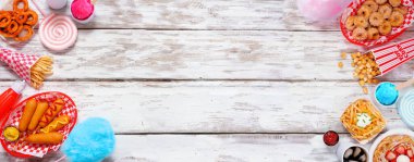 Karnaval temalı yiyecek beyaz ahşap arka planda çifte sınır. Fotokopi alanı ile genel görünüm. Yaz festivali konsepti. Sosisli sandviç, huni keki, pamuk şeker ve atıştırmalıklar..