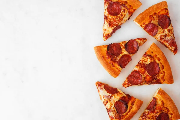Pepperoni Pizza Slice Side Border Top View White Marble Background — 스톡 사진