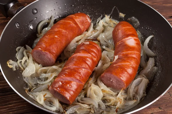 Fried sausage with onions. — Stock Photo, Image