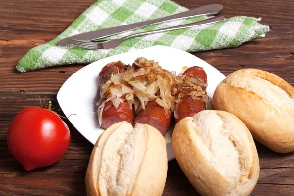 Fried sausage with onions. — Stock Photo, Image