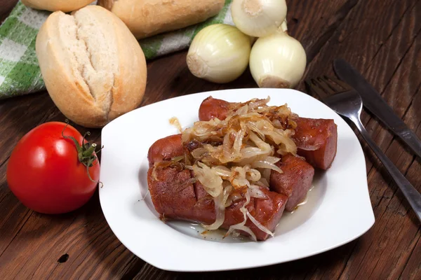 Fried sausage with onions. — Stock Photo, Image