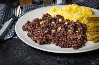 Kızarmış puding, patates püresi ve salatalık turşusu..