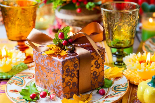 Gift box on festive table — Stock Photo, Image