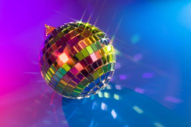 Parlak ışık ve mavi neon arka planda renkli bokeh ile Noel disko topu. Eğlence ya da kutlama için şenlikli konsept.
