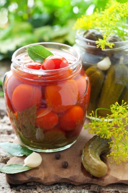 jars of marinaded vegetables(tomatoes and cucumbers)