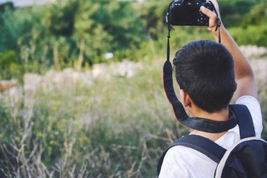 Young Child Taking Photos in the street.