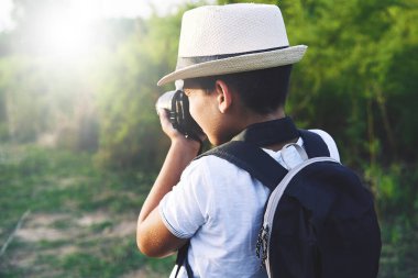 Young Child Taking Photos in the street.