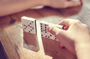 Tahta bir masada domino oynayan bir aile..