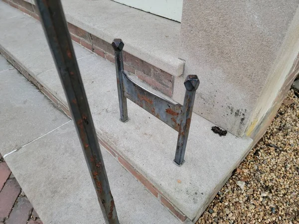 Metal boot or shoe scraper on cement stairs or steps — Stockfoto