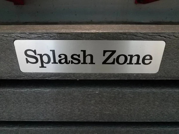 Metal Splash Zone Sign Warning Wood Fence Water — Stock Photo, Image