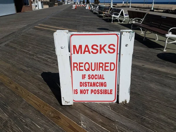masks required if social distancing is not possible signage on boardwalk
