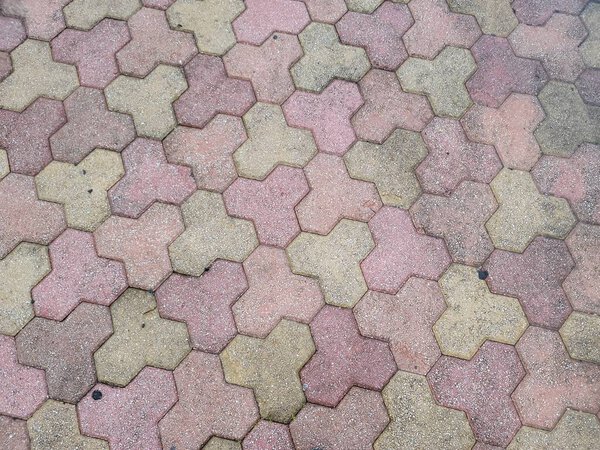 Pink and grey tessellation design on stone tiles on ground