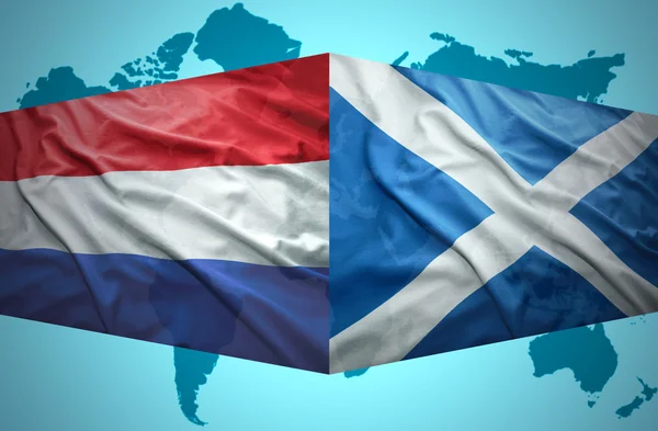 Waving Scottish and Dutch flags — Stock Photo, Image