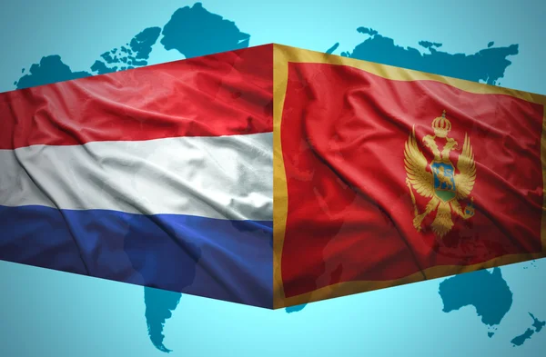 Mává černohorského a nizozemské vlajky — Stock fotografie