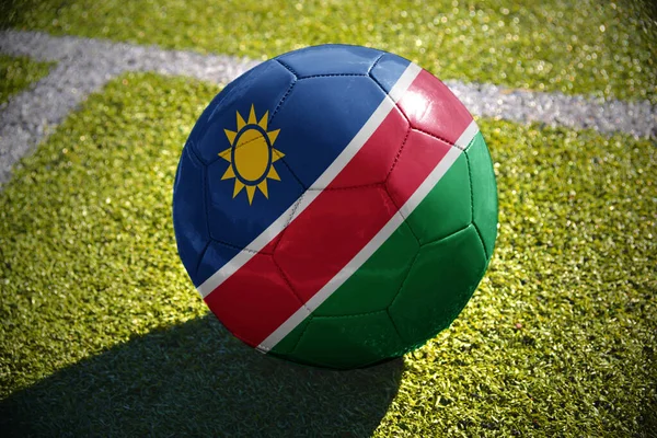 Футбольный Мяч Национальным Флагом Намибии Лежит Зеленом Поле Рядом Белой — стоковое фото