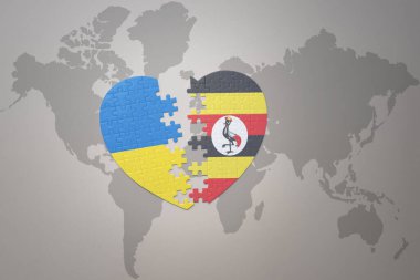 Ukrayna 'nın ulusal bayrağı ve Uganda' nın yapboz kalbi dünya haritasının arka planında. Kavram. 3B illüstrasyon