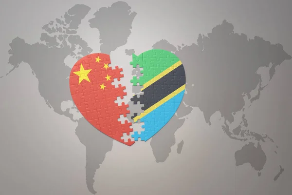 パズルハートは中国とタンザニアの国旗を背景にした世界地図です コンセプト 3Dイラスト — ストック写真