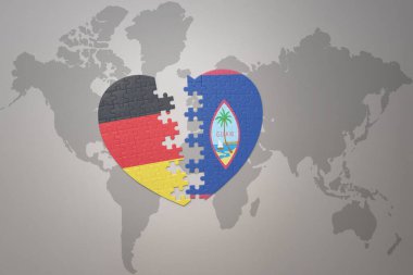 Dünya haritasında Guam ve Almanya 'nın ulusal bayrağı olan bir yapboz kalbi. Kavram. 3B illüstrasyon