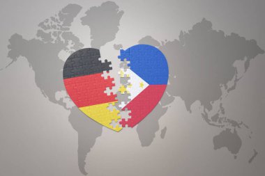 Dünya haritasının arka planında Filipinler ve Almanya 'nın ulusal bayrağı olan bir bulmaca kalbi. Kavram. 3B illüstrasyon