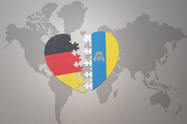Kanarya adalarının ulusal bayrağı ve dünya haritasının arka planında Almanya 'nın bulmaca kalbi. Kavram. 3B illüstrasyon