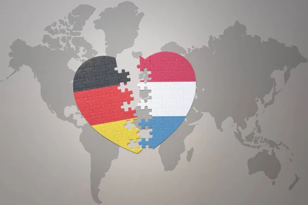 Puzzle Heart National Flag Luxembourg Germany World Map Background Concept — Stock Photo, Image